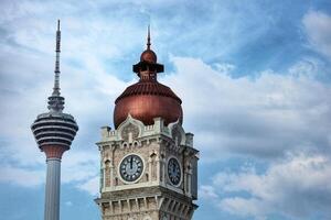 Kuala Lumpur, Malaysia on May 22, 2023. Close up of the clock tower, Big Ben Malaysia. Seen the Kuala Lumpur Tower. Near Masjid Jamek station. photo