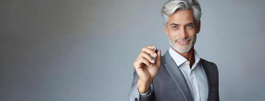 AI Generated Mature businessman holding a pen writing business plan on glass wall at office. Successful male entrepreneur in suit noting information about working project. Empty background, copy space photo