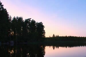 Sunset on a lake in Sweden. Blue hour on calm water. Nature photo from Scandinavia