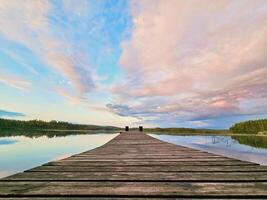 Wooden jetty jutting into a Swedish lake. Nature shot from the Scandinavian photo