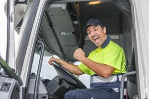 Cheerful male driver opening mouth in excitement while driving truck photo