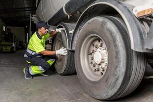 Mechanic checking the wheel of a truck photo