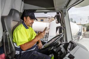 Male driver using smartphone in truck photo