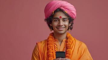 ai generado joven indio hombre utilizando móvil teléfono y vistiendo turbante en contra rosado antecedentes foto