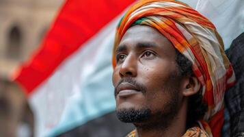 AI generated Arabian man in a headscarf looks ahead against flag of Yemen. photo