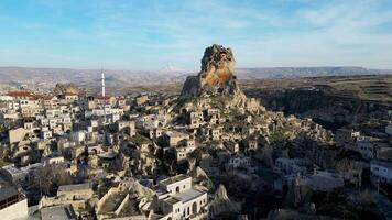 Aerial drone view of the Ortahisar Castle in Cappadocia, Turkey with the snow capped Mount Erciyes in the background. video