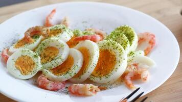 boiled eggs with boiled shrimp in a plate for breakfast video