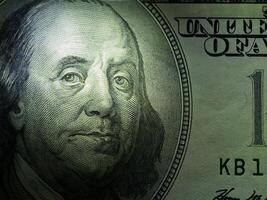 Low key image close up of face on dollar photo