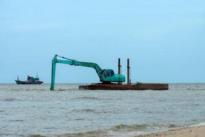 Machines are dredging sand in the sea. photo