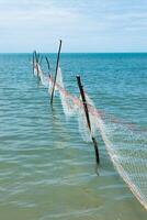 Net fishing in the ocean when the water receded. photo