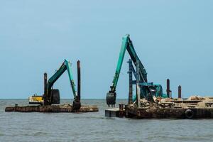 Machines are dredging sand in the sea. photo