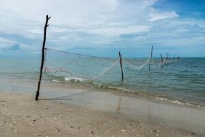 Net fishing in the ocean when the water receded. photo