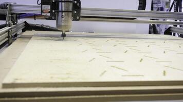 Close-up of carpenter's machine cutting wooden boards. Media. Beautiful patterns on wood with automated machine. Wood carving by automated machine photo