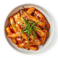 AI generated Fiery and flavorful tteokbokki spicy rice cakes isolated on a clean white background, iconic Korean street food photo