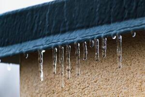 Frozen roof with small stalactites, dark zincwork and light plaster photo