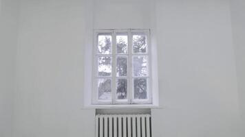 Blank white wall with window. Slide motion of movement or hitting the camera on empty light white room with window. Construction Home Empty room interior window aluminum on wall photo