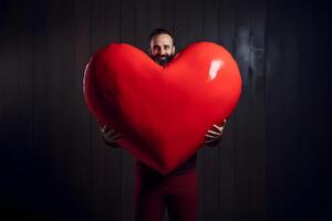 AI generated adult Caucasian man in red pants holding big red heart on black vertical wooden planks board wall background, neural network generated photorealistic image photo
