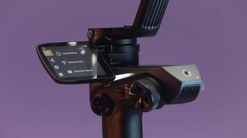 The concept of shooting with gadgets. Action.A large swivel tripod on which a large video camera is attached shoots in different directions on a bright purple background. photo
