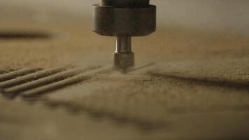 Close-up of machine for patterns on wood. Creative. Industrial machine with cutting needle on surface of wooden board. Automated machine carves patterns on wood photo