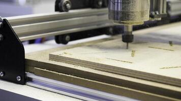 Close-up of carpenter's machine cutting wooden boards. Media. Beautiful patterns on wood with automated machine. Wood carving by automated machine photo