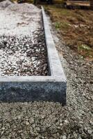 Concrete garden borders with cement to demarcate paths, parkings, sidewalks and flowerbeds photo