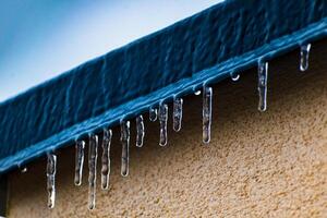 Frozen roof with small stalactites, dark zincwork and light plaster photo