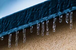 Frozen roof with small stalactites, dark zincwork and light plaster photo