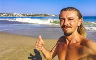 Selfie with rocks cliffs view waves beach Puerto Escondido Mexico. photo