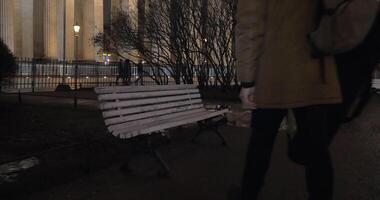 Man sitting down on the bench in park during evening walk video