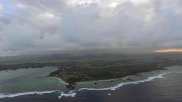 Aerial shot of Mauritius with low clouds and blue lagoons video
