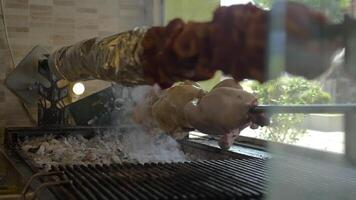 Roasting meat on skewer in cafe video