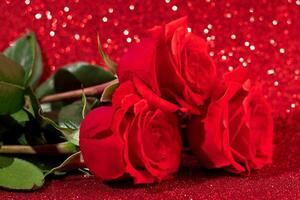 Bouquet of red roses on a shiny bokeh background. Valentine's day concept, place for text. photo