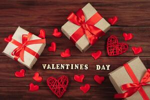 Valentine's day concept. Gifts in craft paper with red ribbons. photo
