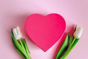 Valentine's day concept. Pink heart and white tulips. Greeting card photo