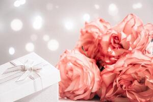 Bouquet of pink roses and gift box on white background. Valentine's day concept. photo