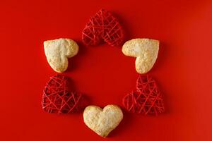 Heart shaped sugar cookies on red background photo