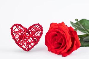 Red rose and hearts on a white background. Valentine's day greeting card. Place for your text. photo