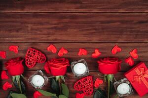 Red roses and hearts on a dark wooden background. Valentine's day postcard concept. photo