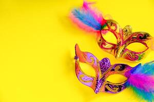 Carnival mask on yellow background. Mardi Gras concept. Fat Tuesday symbol. photo