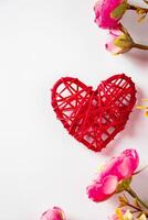 Flowers and red hearts on a white background for Valentine's Day photo