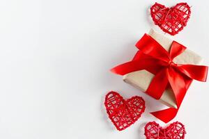 Valentine's day gift and red hearts on a white background photo