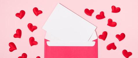 Envelope with greeting card for valentine's day. Romantic holiday concept. Hearts on a pink background. photo