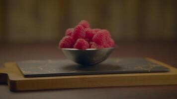 Fresh Ripe Raspberries and Blueberries Standing on Wooden Table video