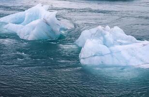 Iceland, Jokulsarlon Lagoon, Turquoise icebergs floating in Glacier Lagoon on Iceland. photo