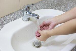 Washing hand on sink photo