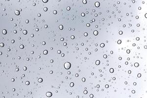 Rainy water drop on glass mirror background. photo