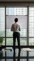 AI Generative Rear back view male entrepreneur holds market writing on white dryerase board strategy business plan makes presentation for investors stands alone against flip chart before start negotia photo