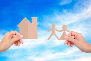 Hands holding family papers on sky background. photo