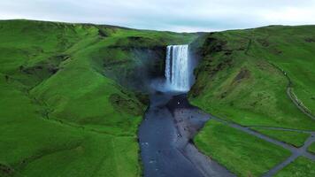 Aerial orbiting view of Skogafoss waterfall in Iceland 4K 30p video