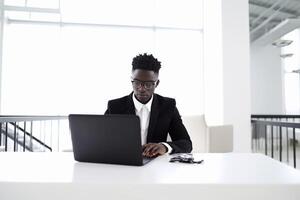 AI Generative Black stressed businessman using his laptop photo